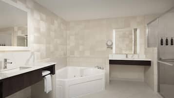 A modern bathroom with a large bathtub, two sinks, and a walk-in shower.