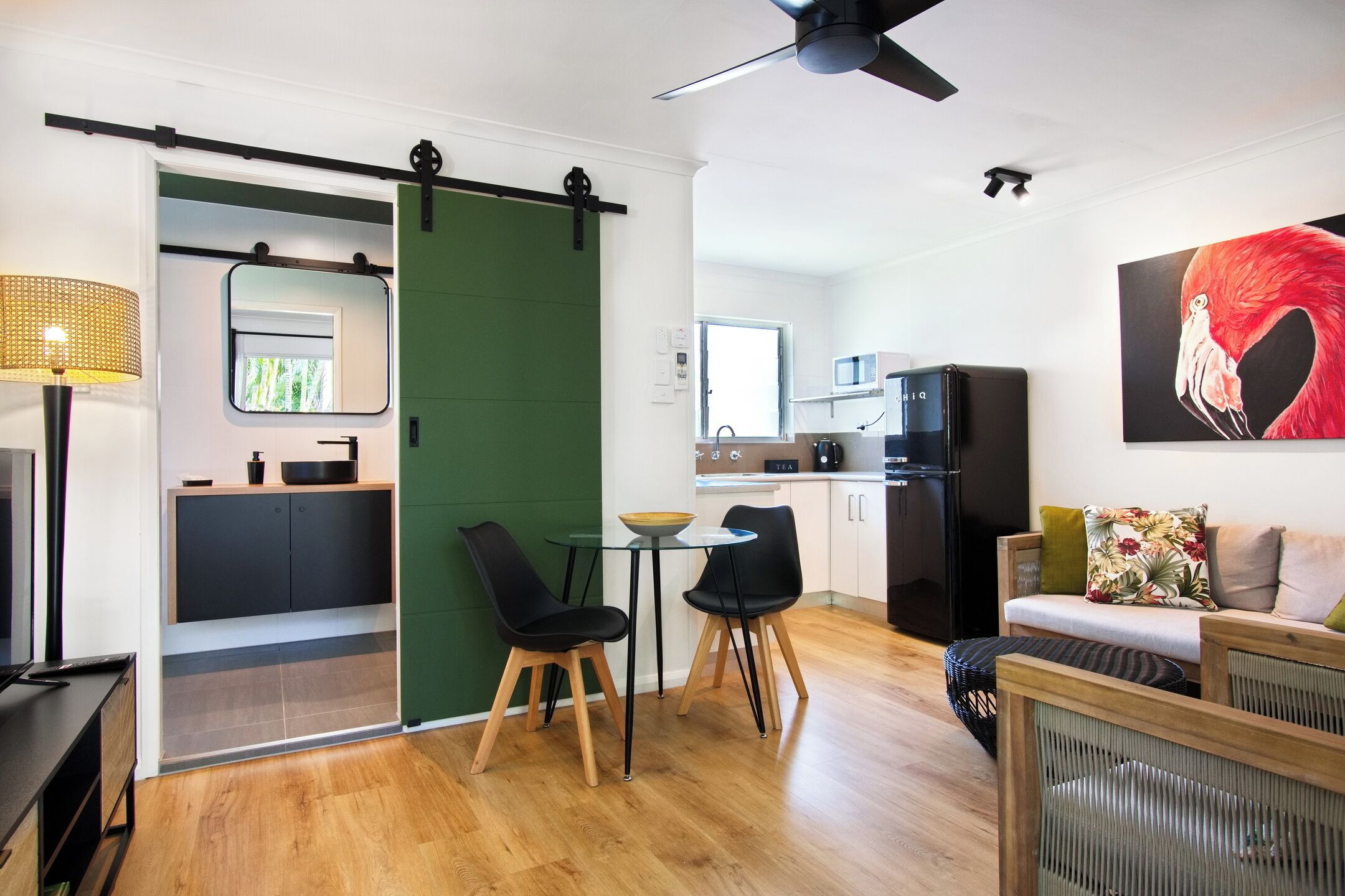 A modern living space with a kitchen, dining area, and seating area.