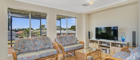 Green Reef Beach House | Living area | Flat-screen TV, DVD player