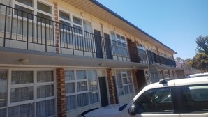 A two-story building with a balcony on the upper floor.