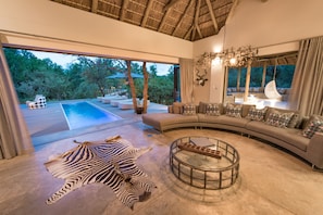 Villa | Living area | 65-inch LED TV with satellite channels, TV, fireplace - Villa Kudu (Hoedspruit)