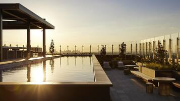 Outdoor pool, open 6:00 AM to 11:00 PM, pool loungers