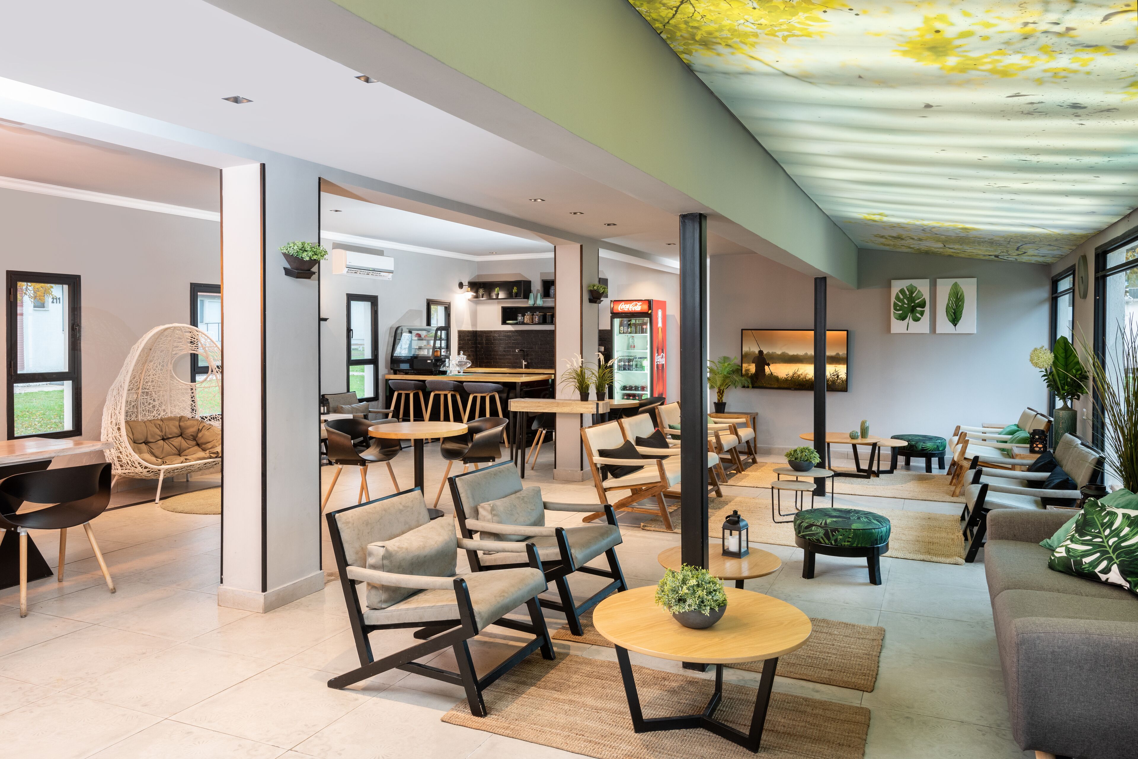 A modern interior with seating areas, a kitchen, and a dining space.