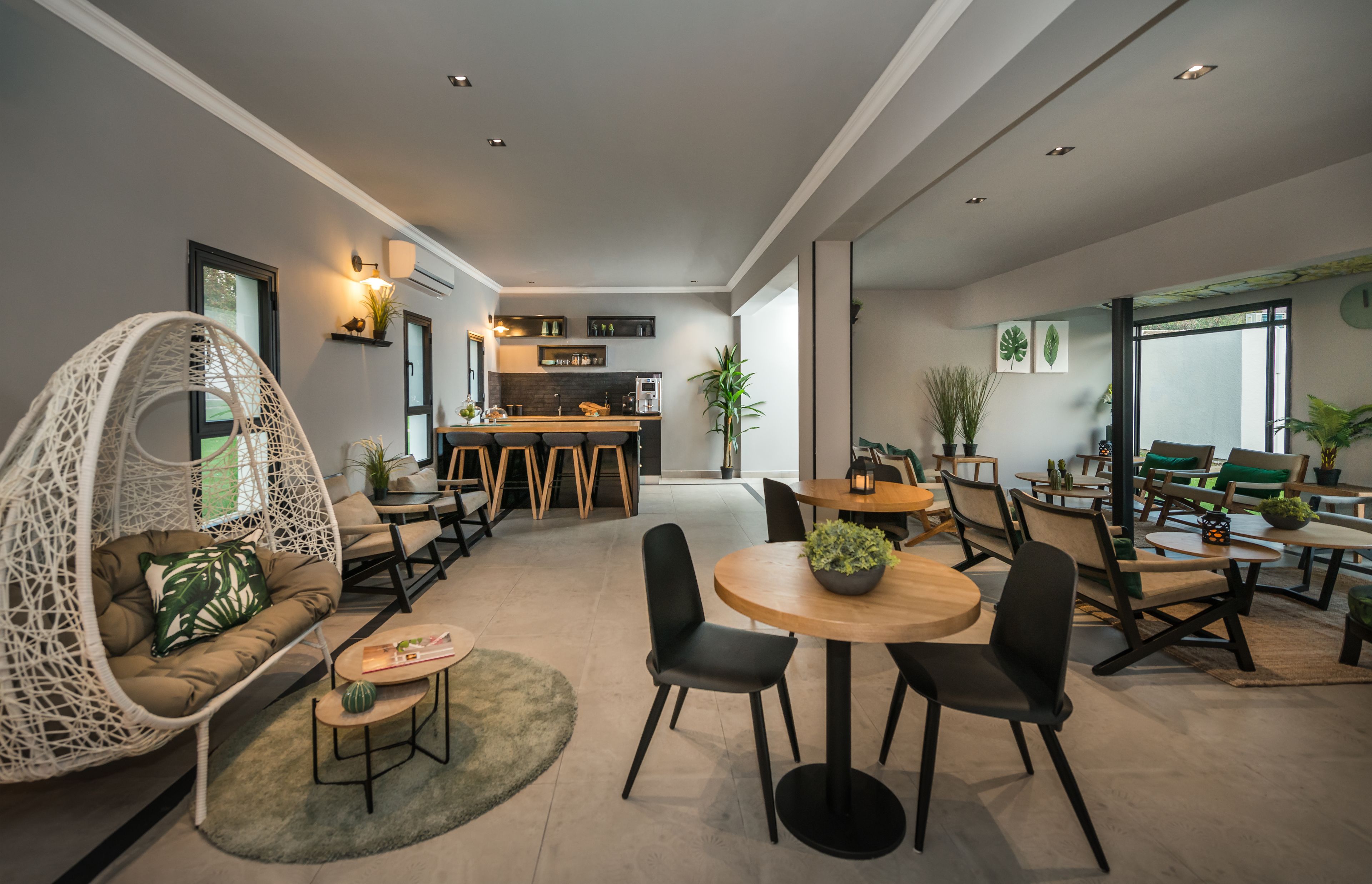 A modern interior with a dining area, kitchen, and seating arrangements.