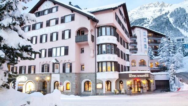 A multi-story hotel with a pink facade, multiple balconies, and a sign reading 'HOTEL ROSATZ.' - Hotel Rosatsch Sleep Only (Pontresina)