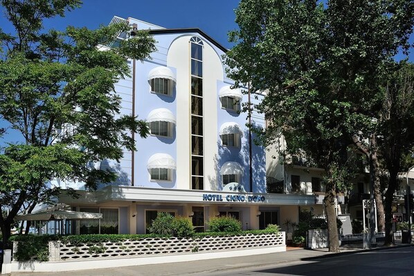 A hotel with a modern facade, multiple balconies, and a clear sign reading "HOTEL CINO DOME".