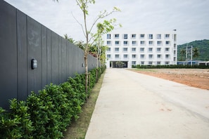 A modern building with a flat roof and a large windowed facade.