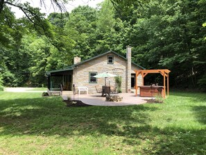 A stone house with a patio, outdoor seating, and a pergola. - Very Private With Hot Tub (Halifax)