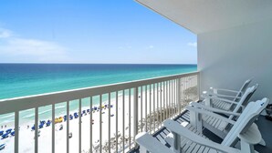 A balcony with a view of a beach and ocean. - Pelican Beach Resort by Colasan (Destin)