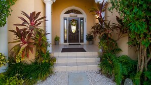 A hotel entrance with a sign reading "SAVHAVEN" and the number "115". - Savhaven - 4 Bed, 4 Bath with Pool, Sleeps 8 (2 minutes away from Spotts Beach) (Savannah)