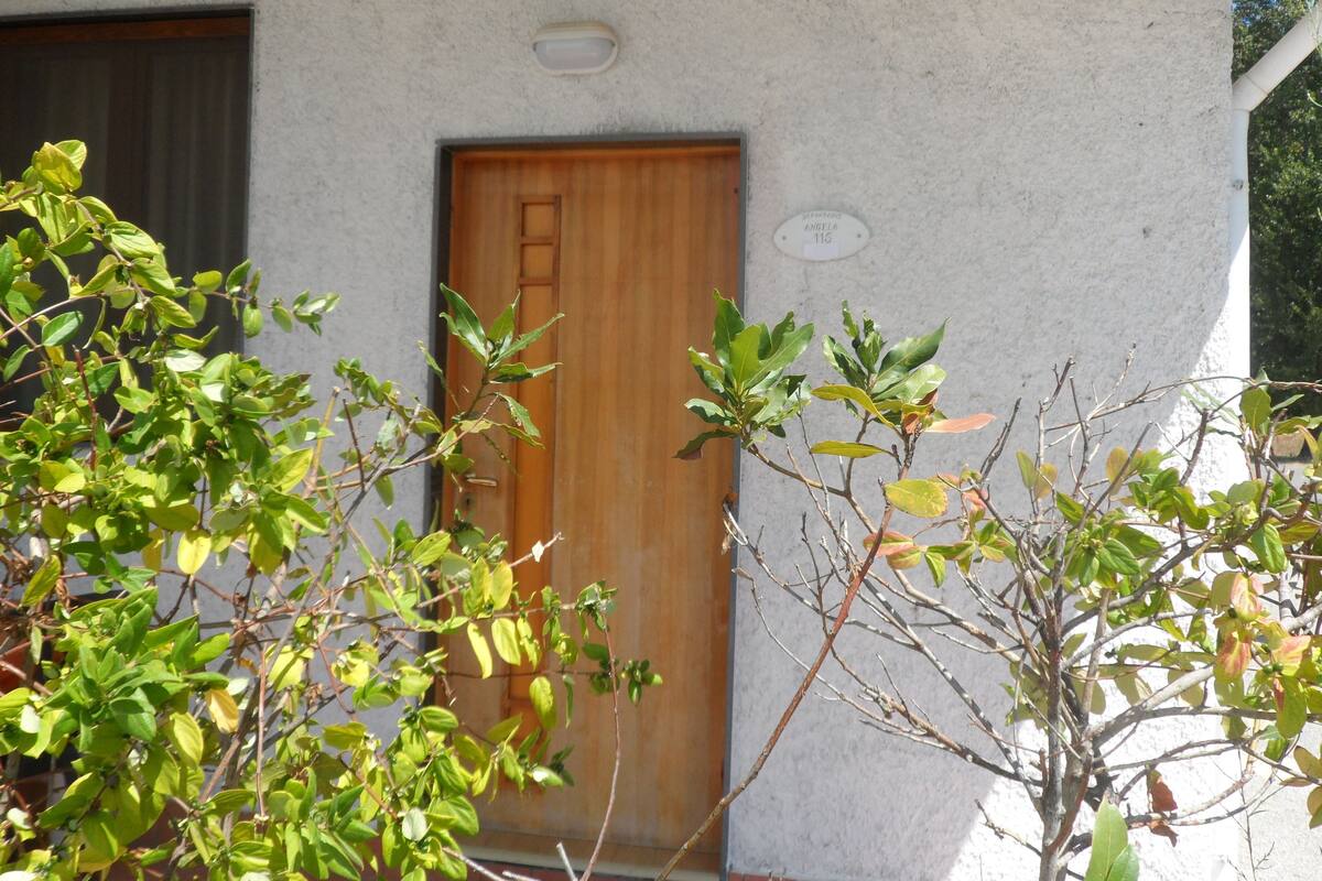A building with a wooden door and a window.