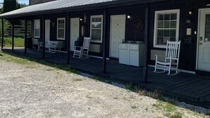 A building labeled "Big South Fork Lodge" with a covered porch, numbered doors, and outdoor seating. - Big South Fork Lodge (Jamestown)