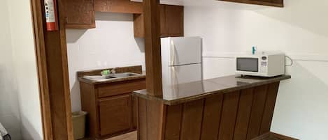 Deluxe Room, Multiple Beds, Refrigerator & Microwave | Private kitchen | Fridge, microwave