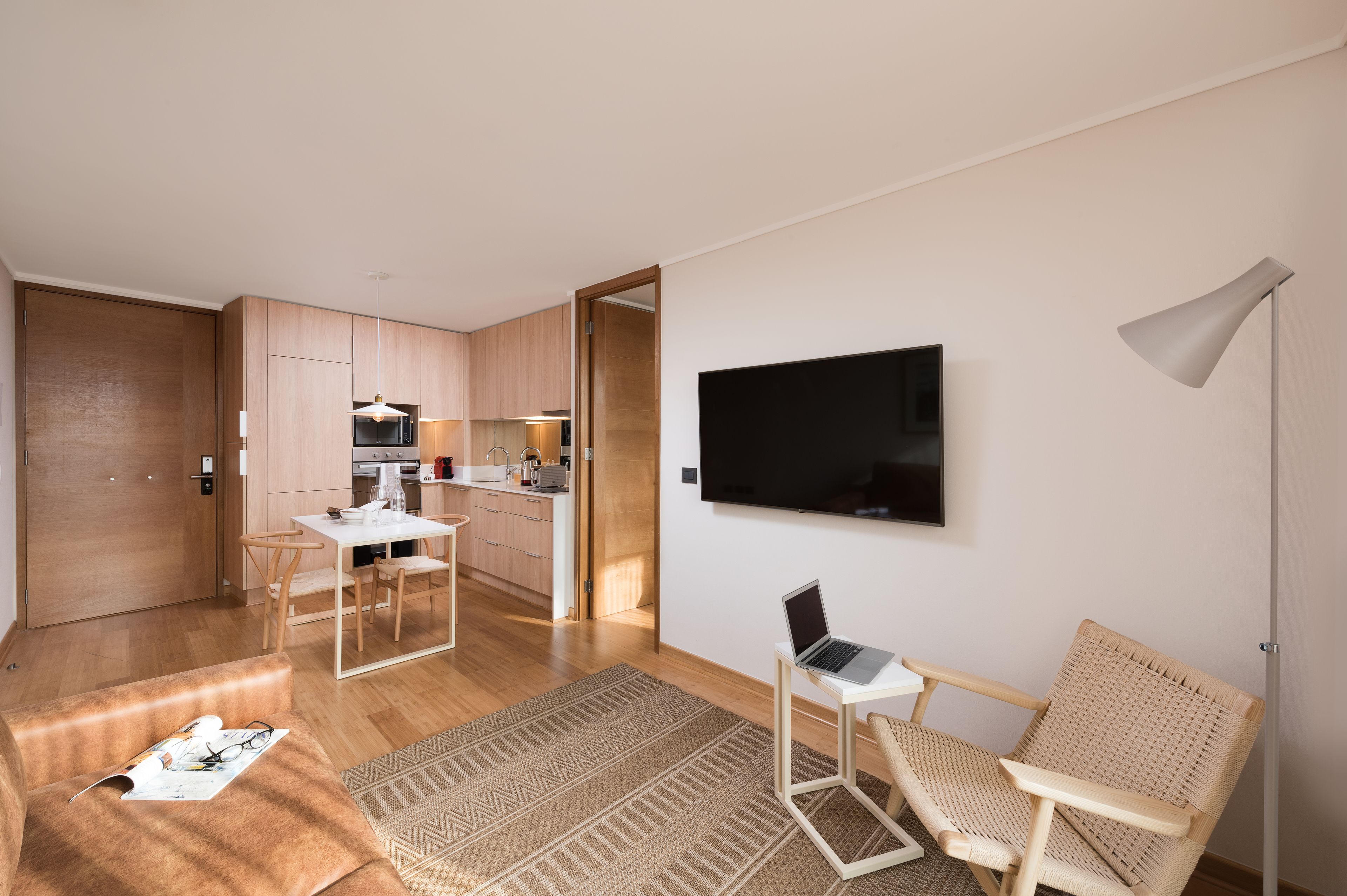 A modern apartment with a kitchen, dining area, and living space.