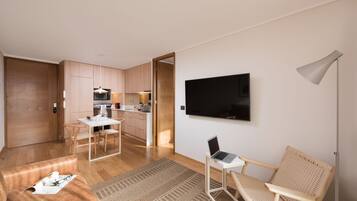 A modern apartment with a kitchen, dining area, and living space.