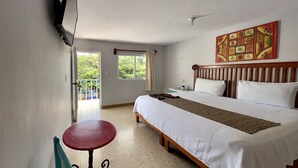 A hotel room with a bed, a table, and a chair. - Blue Coconut Cancun Hotel (Cancun)