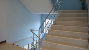 A staircase with a metal handrail leading to an upper floor.