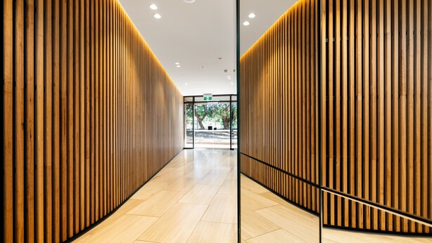 A modern interior with wooden panel walls and a tiled floor. - Anchorage Apartments Hampton (Hampton)