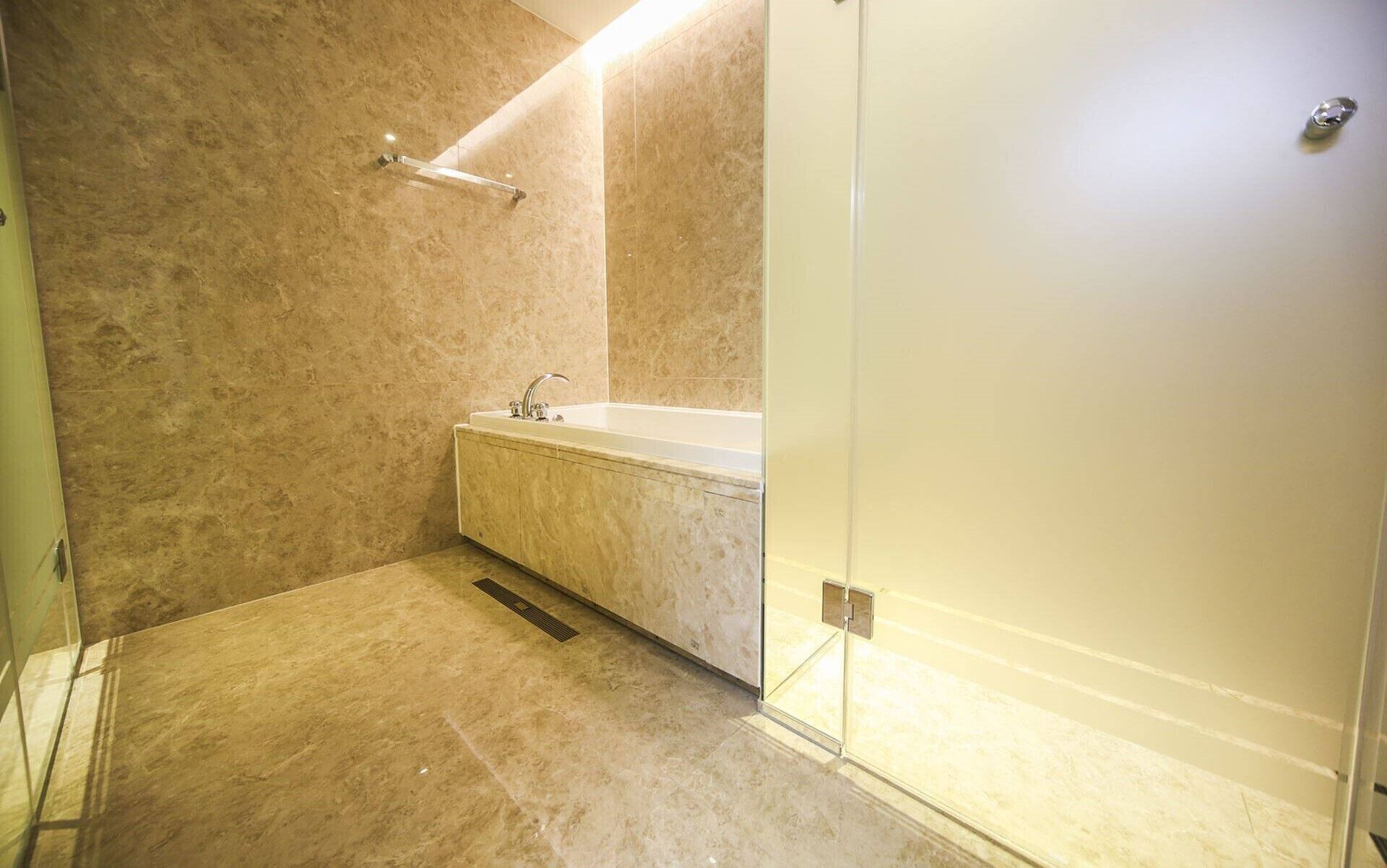 A bathroom with a bathtub, a shower, and a mirror.