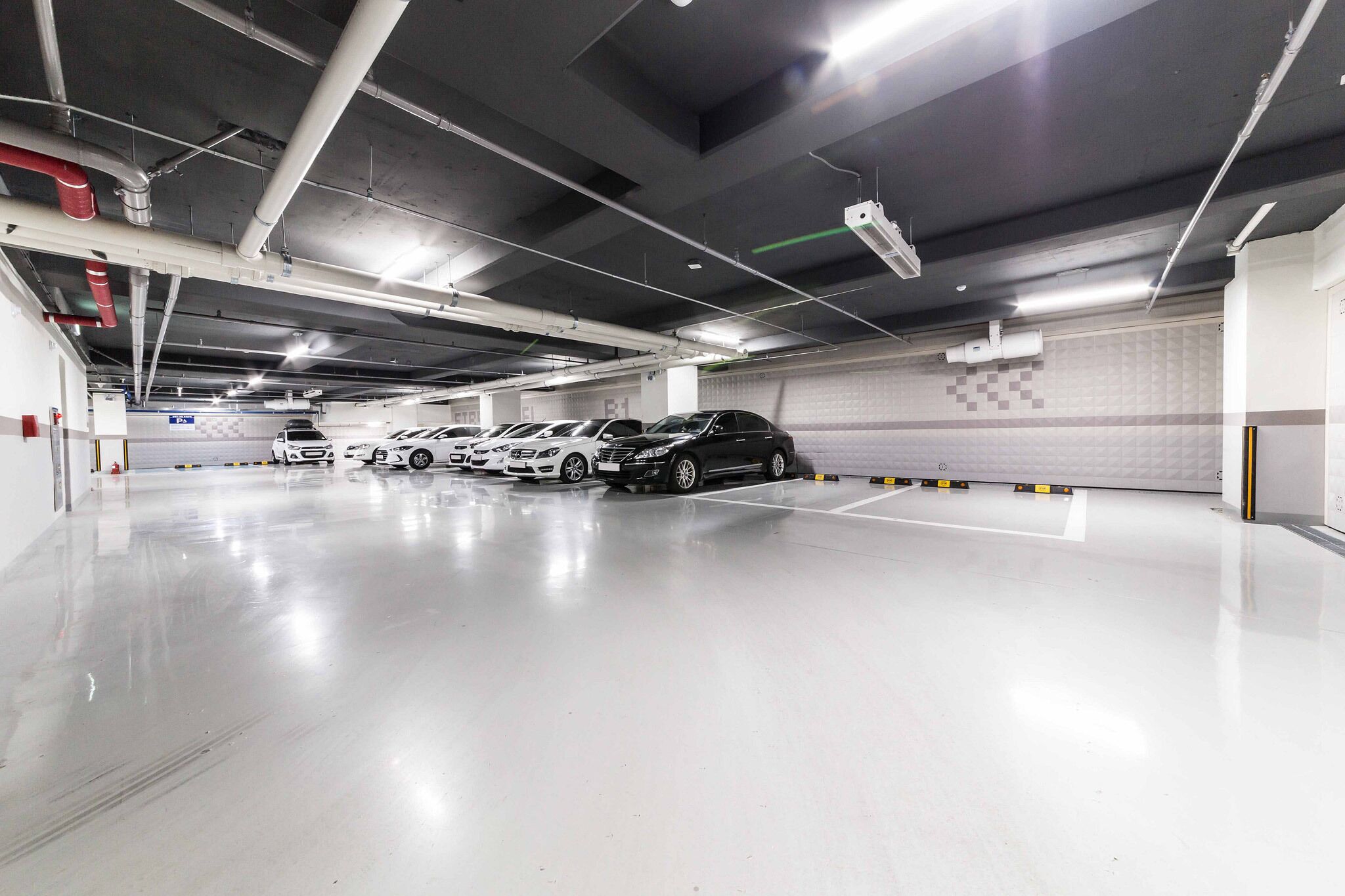 A multi-level parking garage with several cars parked.
