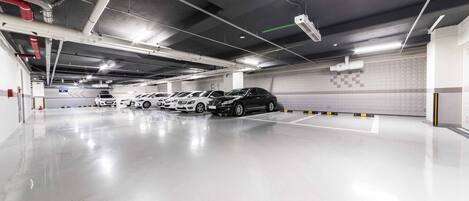 A multi-level parking garage with several cars parked.