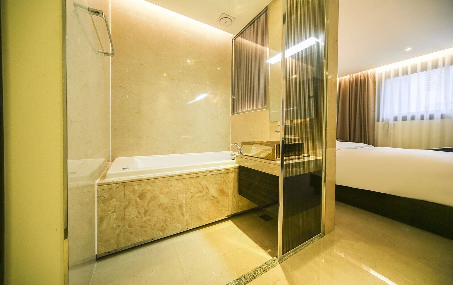 A modern bathroom with a bathtub, a mirror, and a shower.