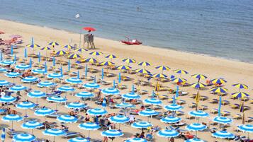 Private beach, white sand, sun loungers, beach umbrellas
