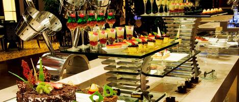 A buffet with various desserts and drinks.