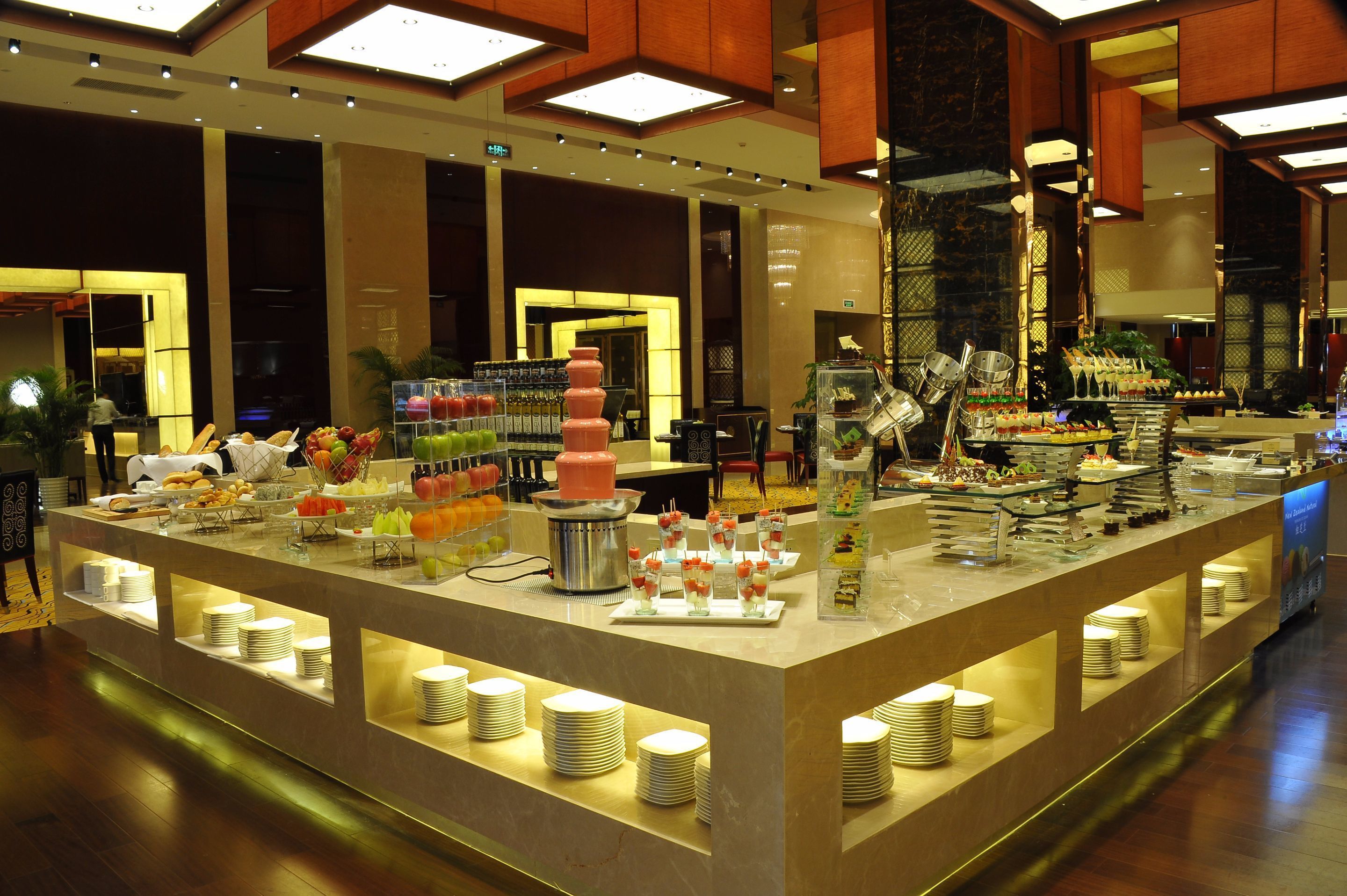 A buffet setup with various food items and drinks.