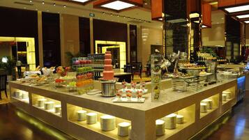 A buffet setup with various food items and drinks.