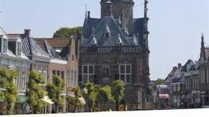 A historic building with a prominent clock tower and traditional architecture.