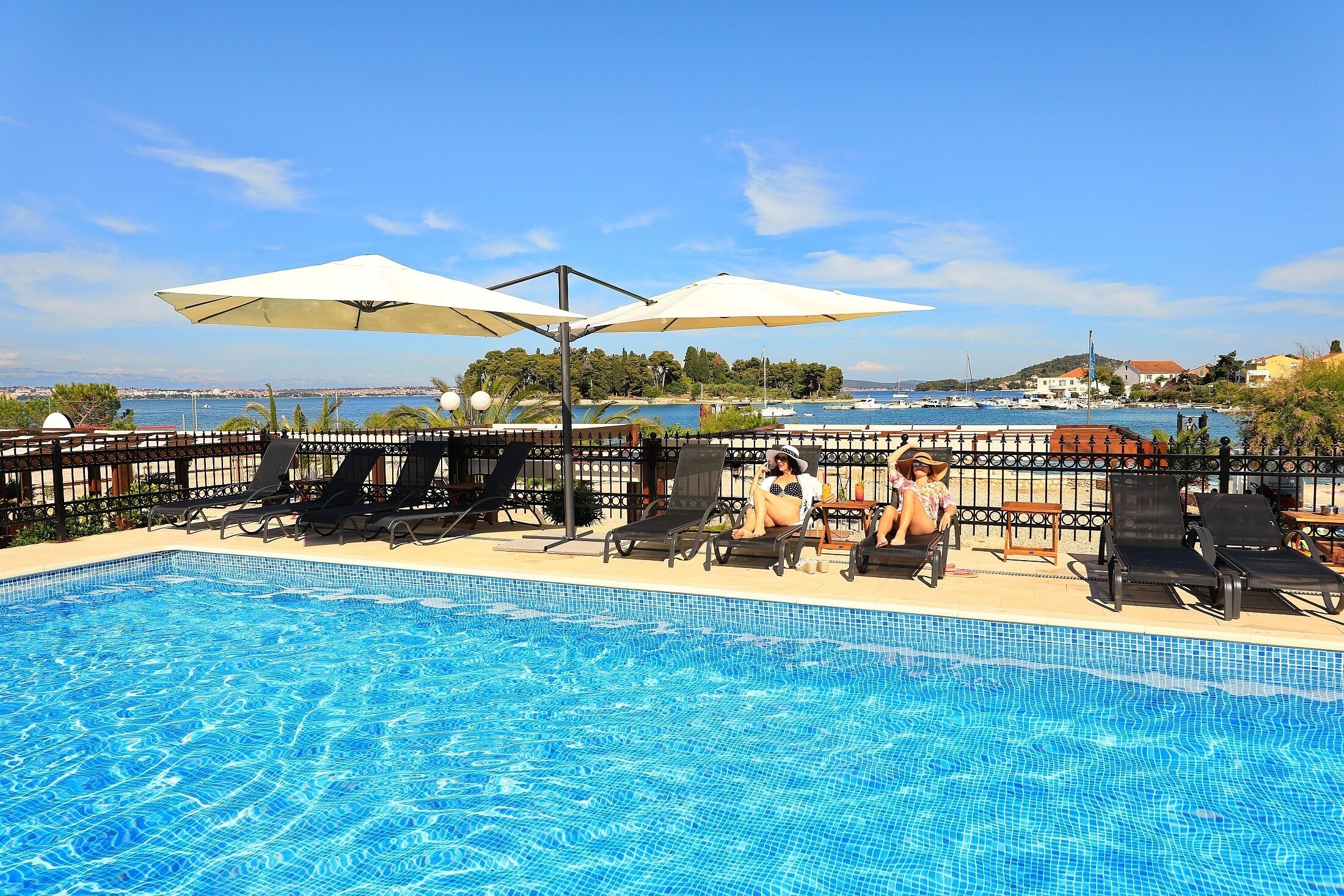 Outdoor pool, open 6 AM to 8 PM, pool umbrellas, sun loungers