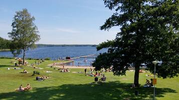 A park with a lake, picnic areas, and a wooden pier.