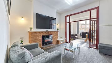 Family Apartment | Living area | 32-inch flat-screen TV with cable channels, TV, Netflix