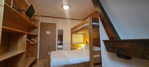 A wooden bunk bed room with a wooden shelf and a flat-screen TV mounted on the wall. - Chalet 1200 (Saint-François-Longchamp)