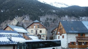 A white bus parked in front of a building labeled "Hotel Restaurant." - Chalet 1200 (Saint-François-Longchamp)