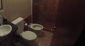 Un baño con lavamanos, inodoro y bidé.