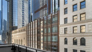 A modern building with large windows and a balcony.
