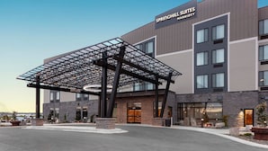 A modern hotel with a covered entrance, a sign reading "Springhill Suites Marriott," and a stone facade. - SpringHill Suites by Marriott Great Falls (Great Falls)