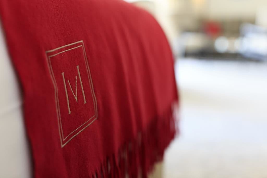 A red fabric with a monogrammed logo.