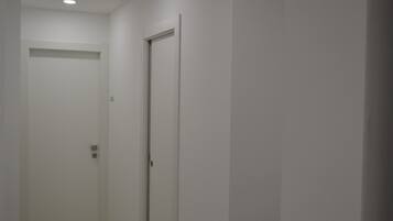 A narrow hallway with a closed door at the end.