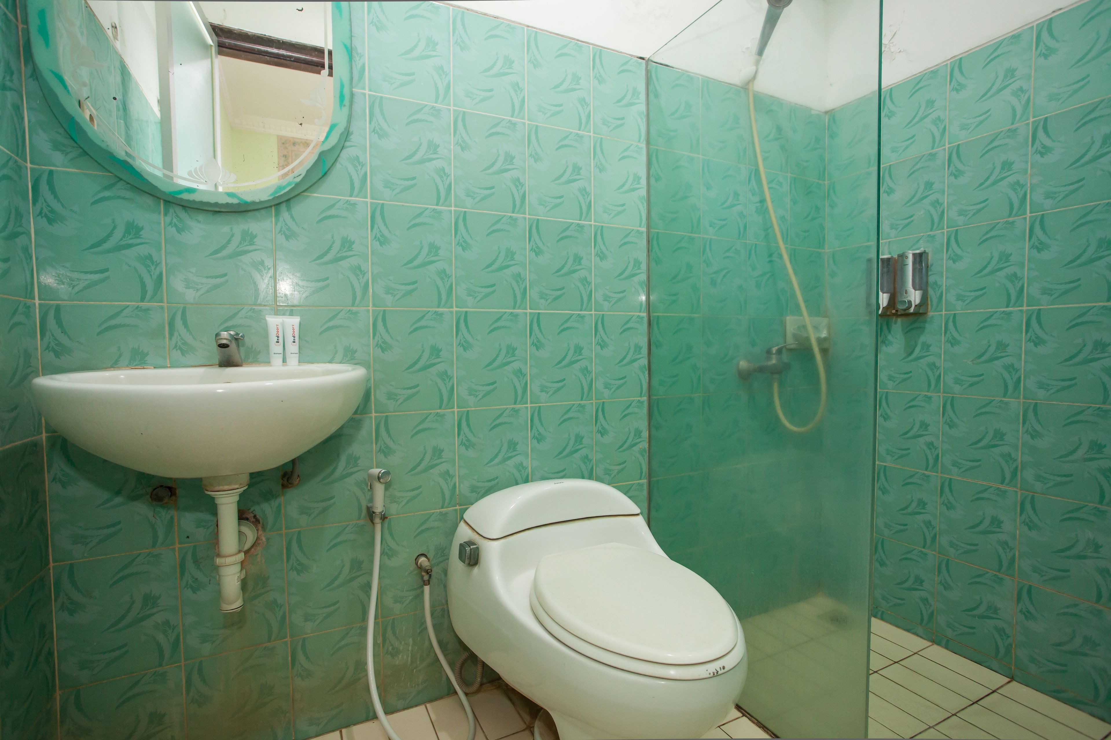 A bathroom with a sink, toilet, and shower.