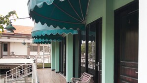 A building with a green awning and a door with the number 4. - RedDoorz near Juanda International Airport (Sidoarjo)
