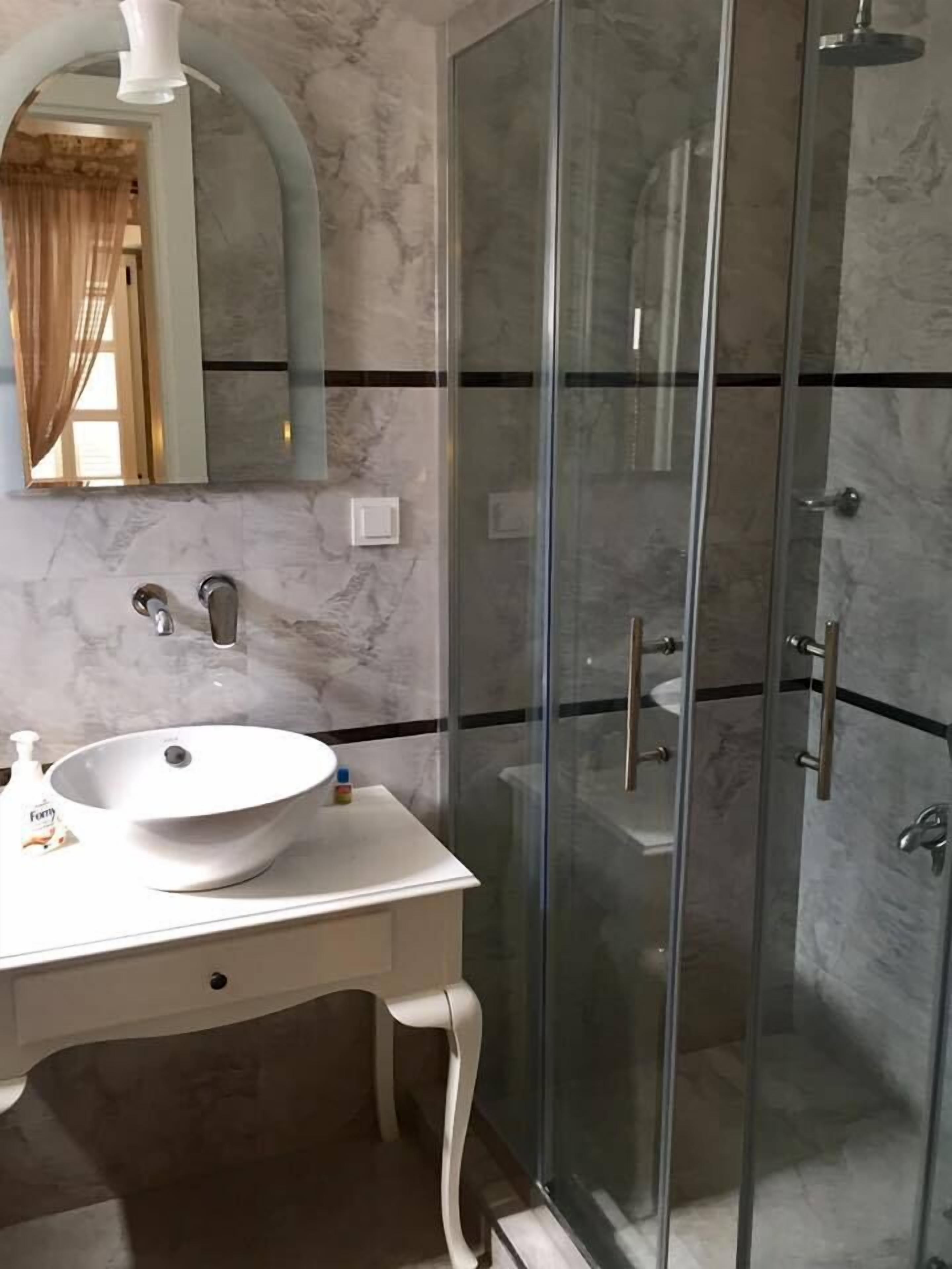 deluxe room | bathroom | shower, free toiletries, hair dryer, slippers