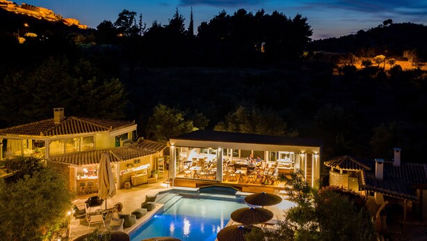 A resort with a swimming pool, outdoor seating, and a bar area. - Anthemion Suites & Villas (Nafplio)