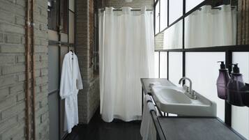 TOÑA Deluxe Room | Bathroom | Shower, rainfall showerhead, designer toiletries, hair dryer