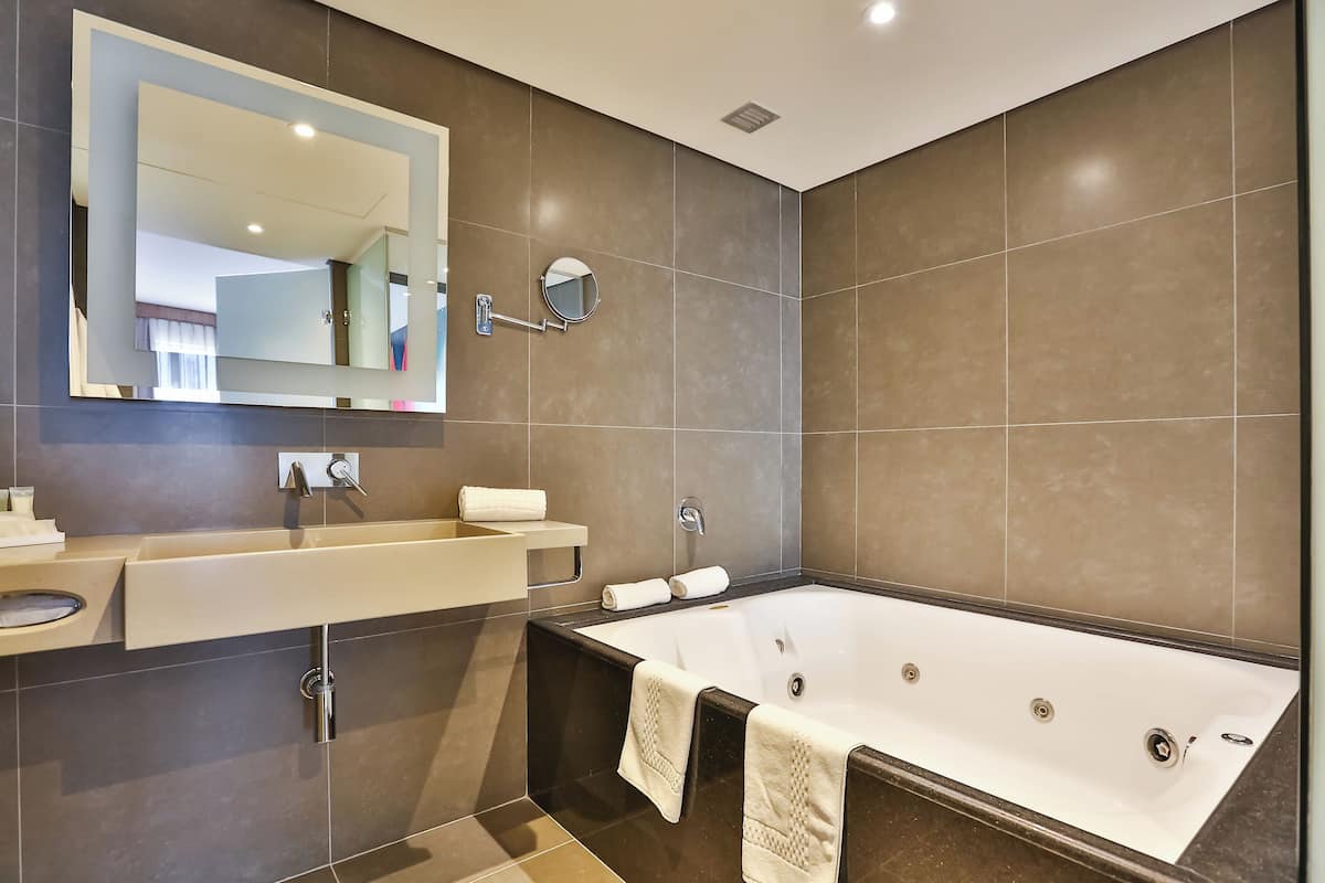 Superior Suite, 1 King Bed | Bathroom | Rainfall showerhead, eco-friendly toiletries, hair dryer, towels