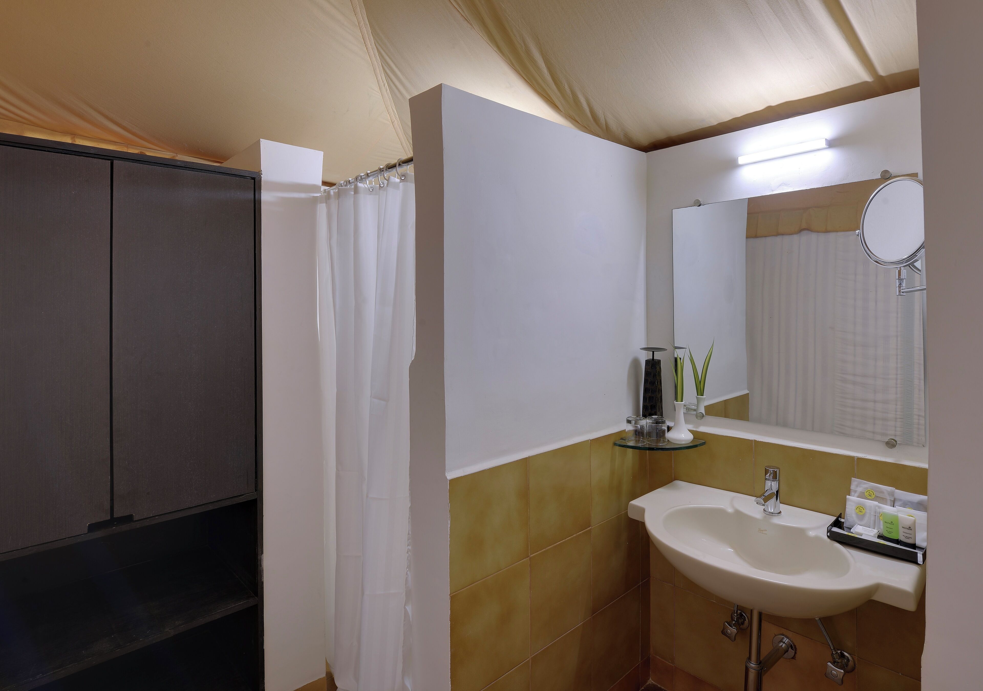 A bathroom with a shower, a sink, and a mirror.