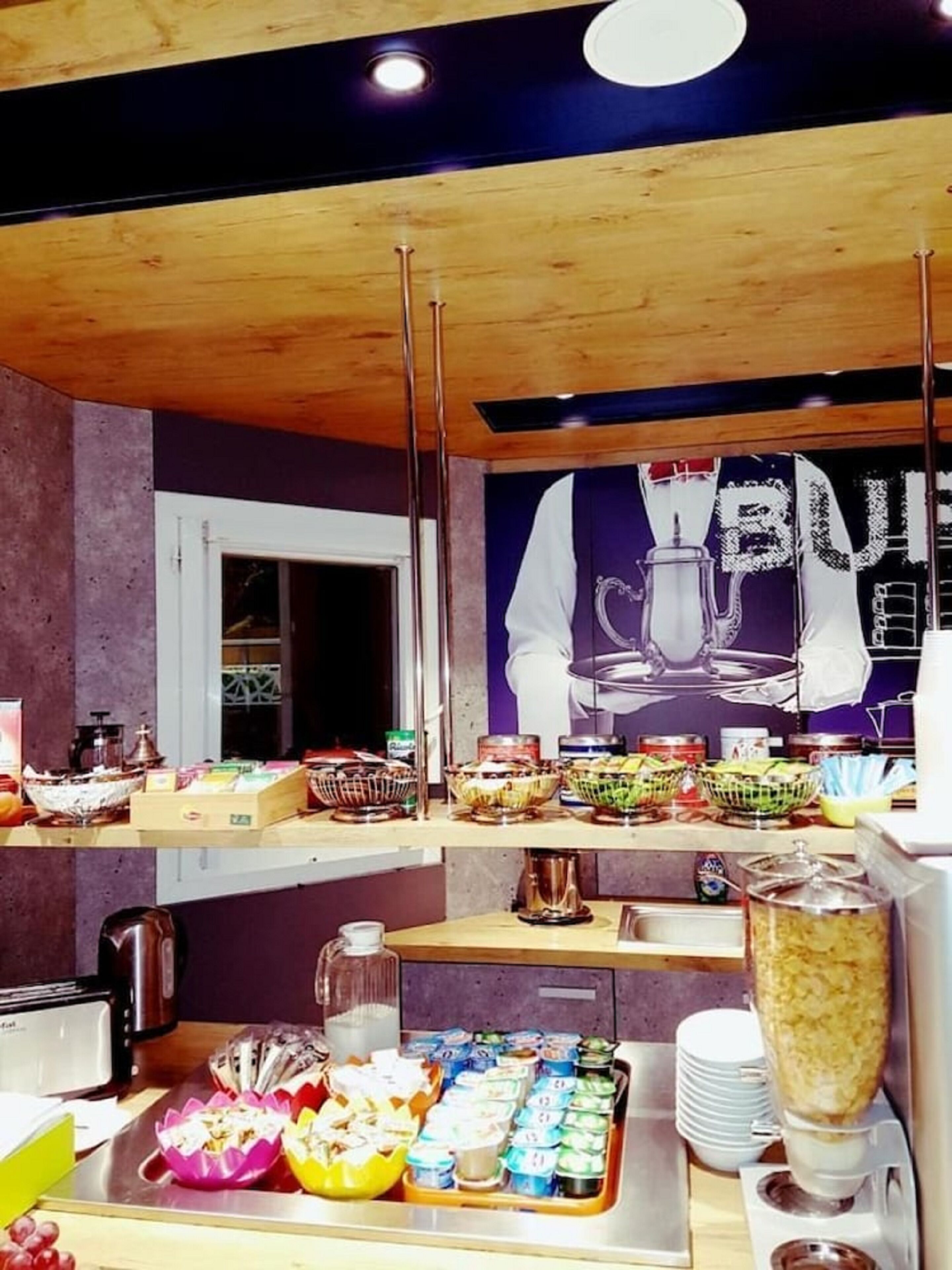 A breakfast buffet with various food items and a coffee machine.