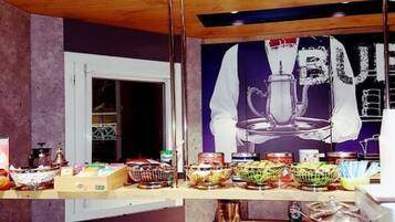 A breakfast buffet with various food items and a coffee machine.